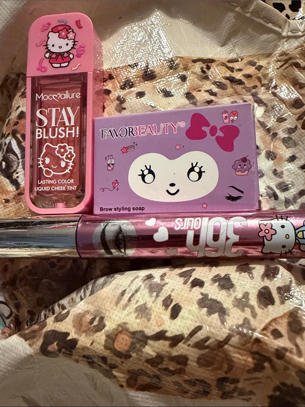 Hello Kitty Pink and Purple Cosmetic Kit with Bow Graphic filled with makeup